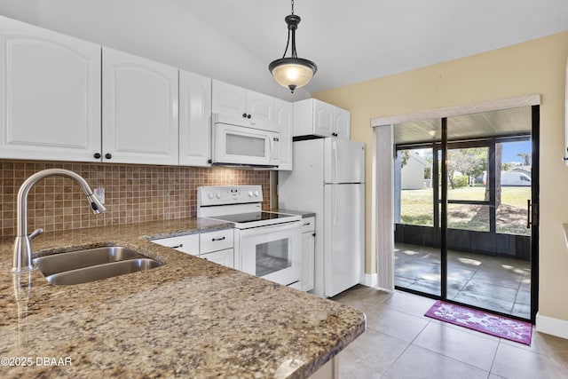 kitchen featuring white appliances, decorative light fixtures, and white cabinetry