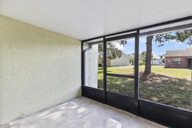 unfurnished sunroom featuring plenty of natural light and wood ceiling