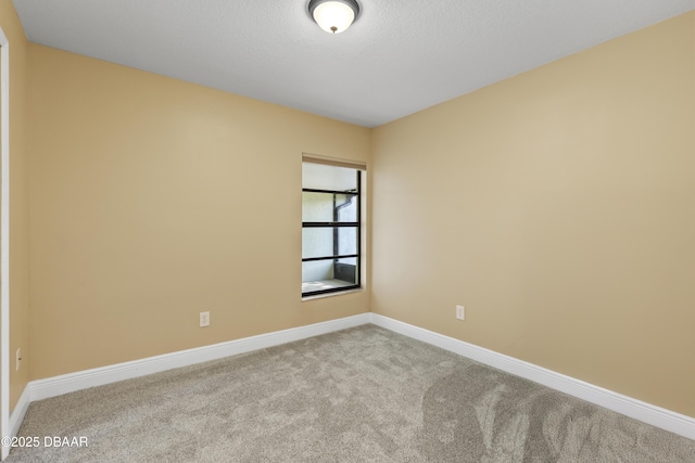 unfurnished room featuring light carpet