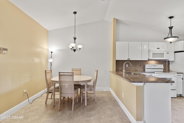 tiled dining room with sink, vaulted ceiling, and a notable chandelier