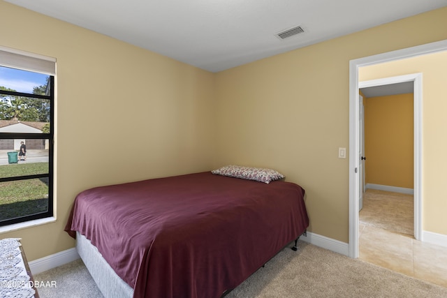 bedroom with light colored carpet