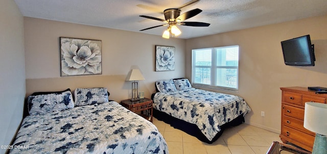 bedroom with light tile patterned floors, baseboards, a textured ceiling, and ceiling fan