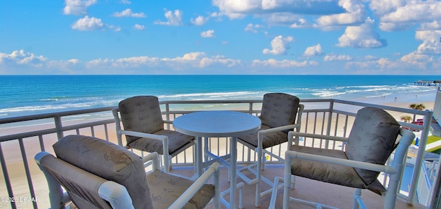 balcony with a beach view and a water view