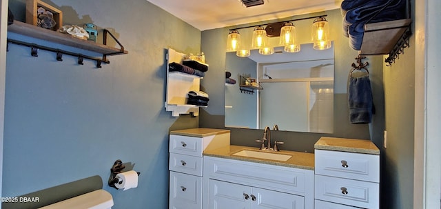 bathroom with a stall shower, visible vents, toilet, and vanity