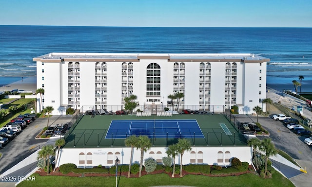 view of building exterior with a water view and fence