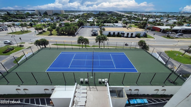 view of sport court featuring fence