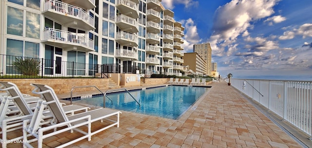 pool with fence and a patio area