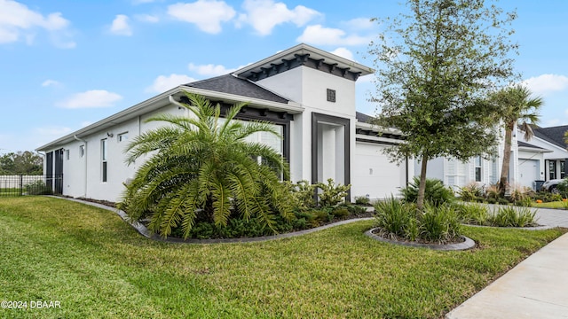 view of front of house featuring a front yard and a garage