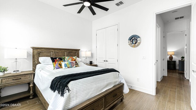 bedroom with ceiling fan, light hardwood / wood-style floors, and a closet