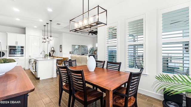 dining space with hardwood / wood-style floors and sink