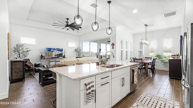 kitchen featuring pendant lighting, white cabinetry, and a wealth of natural light