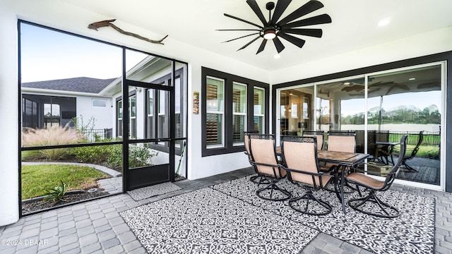 sunroom featuring a wealth of natural light and ceiling fan