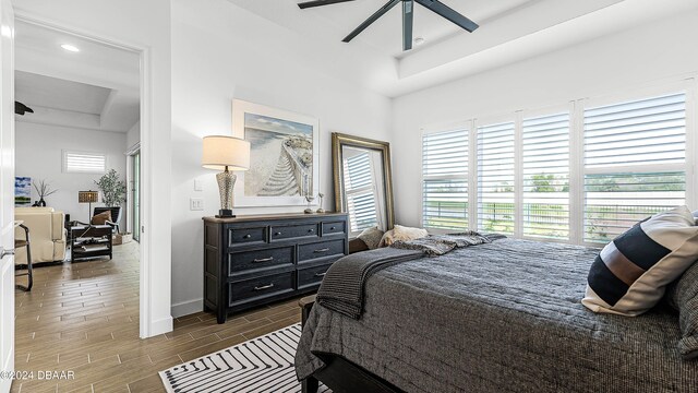 bedroom with ceiling fan and dark wood-type flooring