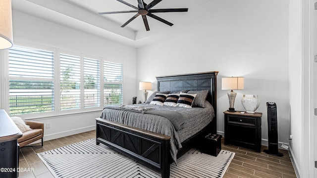 bedroom with ceiling fan and hardwood / wood-style flooring