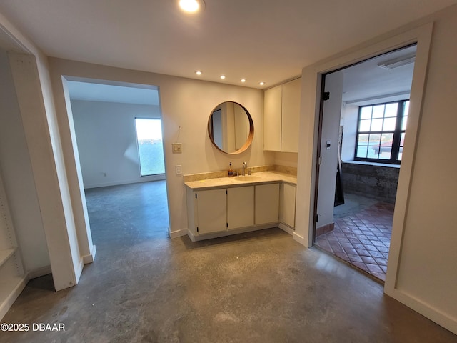 bathroom with vanity and concrete flooring