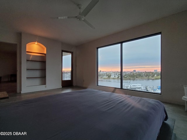 unfurnished bedroom featuring a water view and ceiling fan