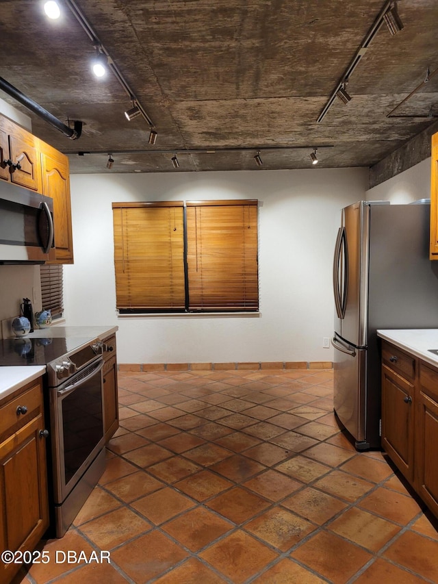 kitchen featuring rail lighting and appliances with stainless steel finishes