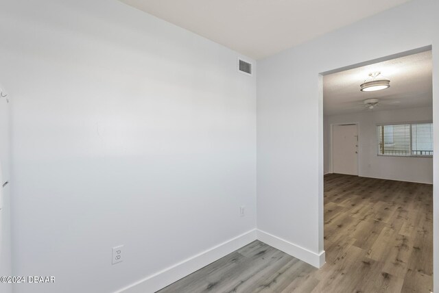 empty room with light hardwood / wood-style flooring