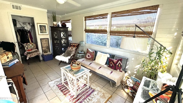 sitting room with tile patterned flooring and ceiling fan