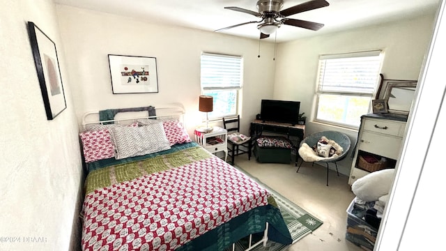 bedroom featuring ceiling fan and multiple windows