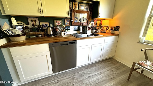 bar featuring stainless steel dishwasher, butcher block countertops, white cabinetry, and sink