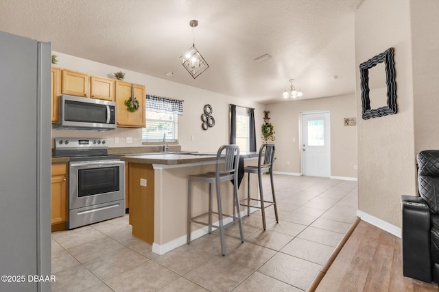 kitchen featuring dark countertops, a healthy amount of sunlight, and stainless steel appliances