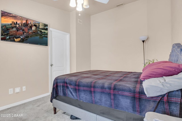 bedroom with visible vents, baseboards, carpet, and a ceiling fan