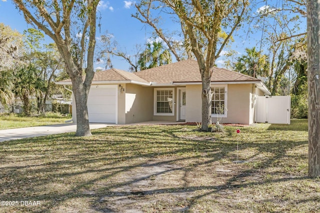 view of front of home featuring a garage, concrete driveway, a front lawn, and stucco siding