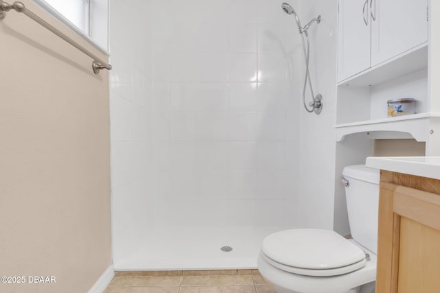 bathroom with toilet, a stall shower, vanity, and tile patterned flooring