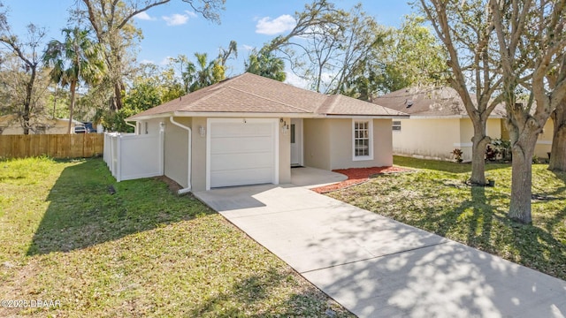 ranch-style home with stucco siding, a front lawn, driveway, fence, and an attached garage