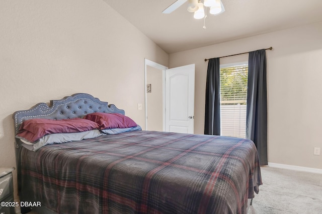 bedroom with ceiling fan, baseboards, carpet, and vaulted ceiling