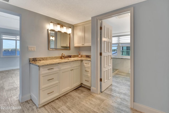 bathroom with vanity and a textured ceiling