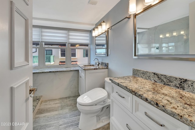 bathroom with vanity and toilet