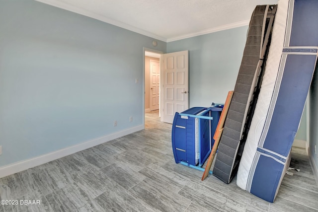 interior space with a textured ceiling and ornamental molding