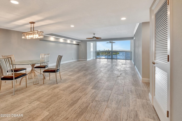 dining space with light wood-type flooring and ceiling fan