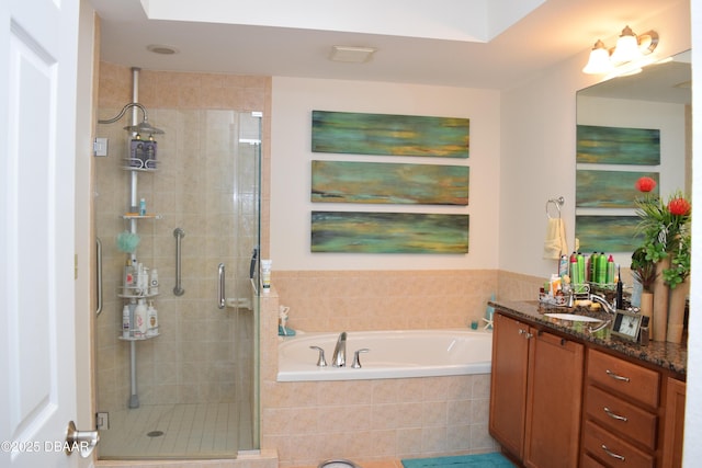 full bath with a garden tub, vanity, and a shower stall