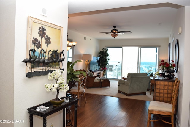 living area featuring a ceiling fan and wood finished floors