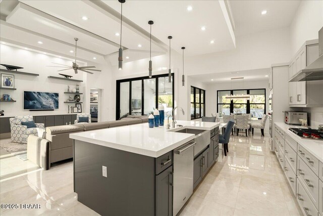 634 Woodbridge Dr, Ormond Beach, FL 32174 - kitchen featuring appliances with stainless steel finishes, light marble finish floors, open floor plan, ceiling fan, and light countertops