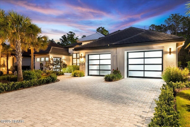 634 Woodbridge Dr, Ormond Beach, FL 32174 - view of front of property featuring decorative driveway, a garage, and stucco siding