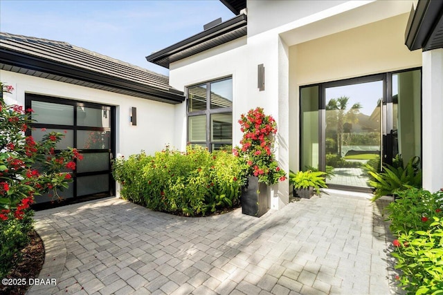 634 Woodbridge Dr, Ormond Beach, FL 32174 - view of exterior entry with stucco siding and a patio