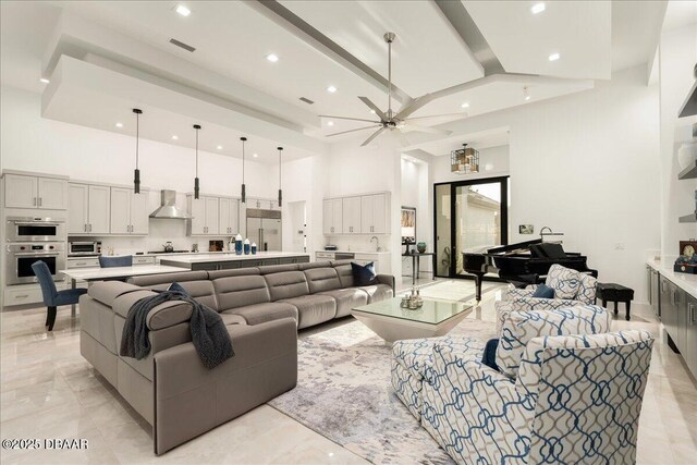 634 Woodbridge Dr, Ormond Beach, FL 32174 - living room with a high ceiling, a ceiling fan, recessed lighting, and light marble finish flooring