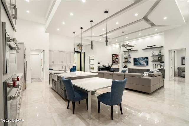 634 Woodbridge Dr, Ormond Beach, FL 32174 - dining area with a towering ceiling, light marble finish floors, a ceiling fan, and recessed lighting
