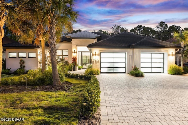 634 Woodbridge Dr, Ormond Beach, FL 32174 - view of front of home with stucco siding, decorative driveway, and an attached garage