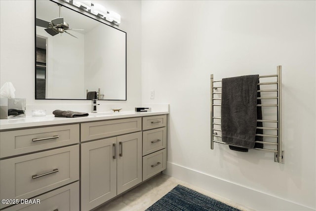 634 Woodbridge Dr, Ormond Beach, FL 32174 - bathroom featuring a towel warmer, vanity, radiator heating unit, and ceiling fan