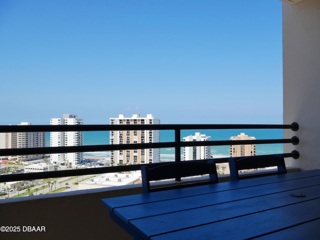 balcony featuring a view of city and a water view