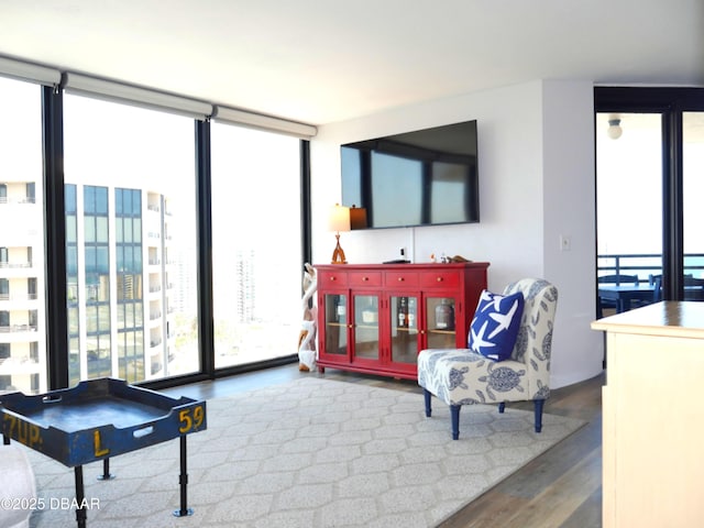 living room with expansive windows and wood finished floors