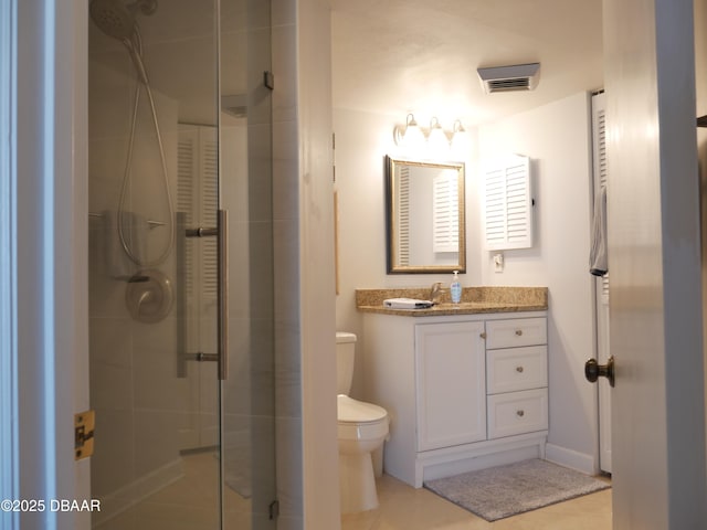 bathroom featuring tile patterned flooring, vanity, visible vents, toilet, and a shower stall