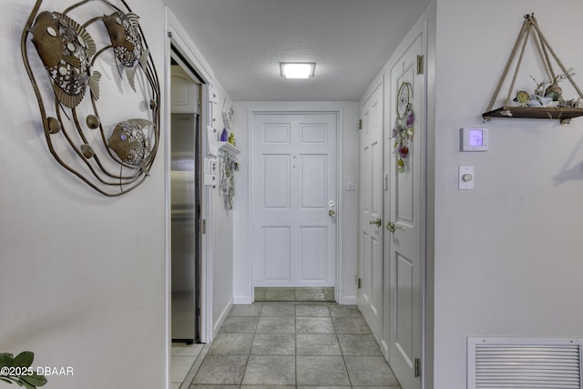 hallway with a textured ceiling