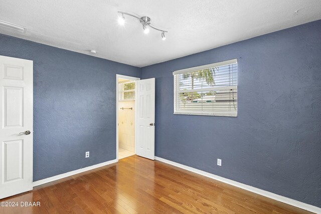 empty room with hardwood / wood-style flooring