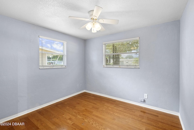 spare room featuring hardwood / wood-style floors, ceiling fan, and a textured ceiling